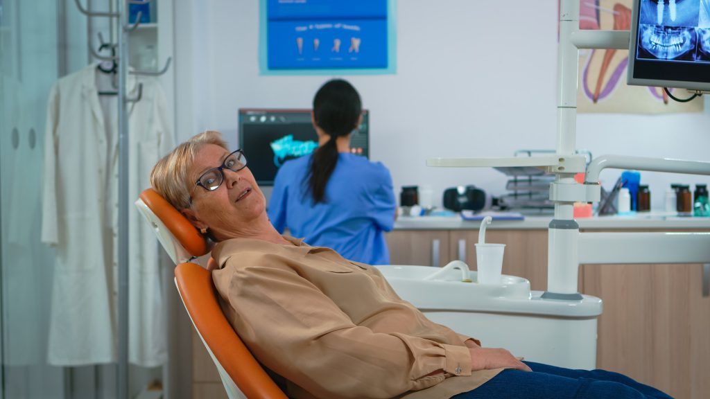 Senior woman looking on camera waiting on dental clinic