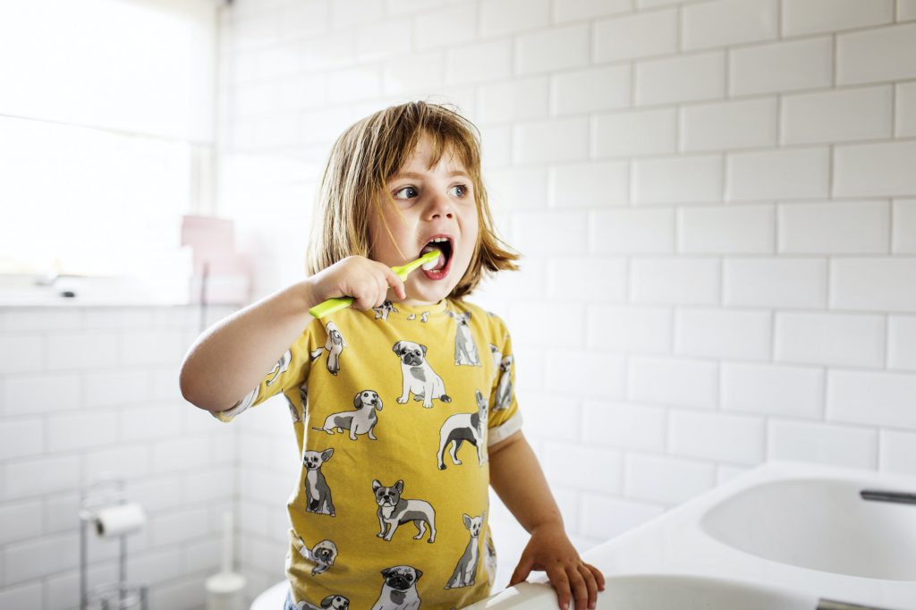 Small girl (2-3) brushing teeth